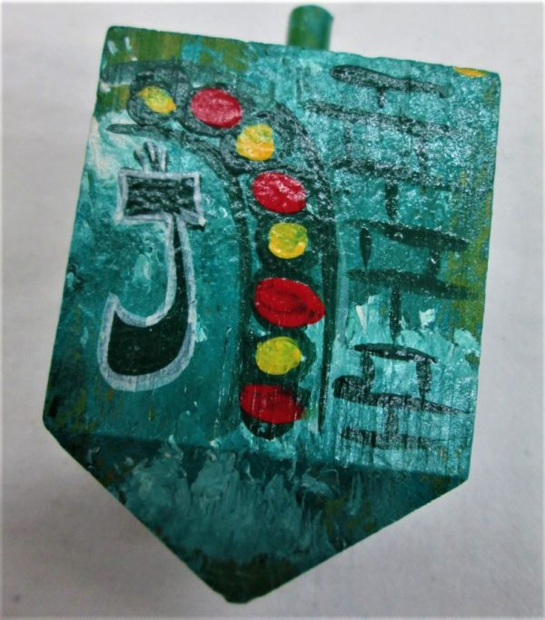 Hanukah Dreidel Painted Wood Sevivon hand painted with green background and designs. Dimension 5 cm X 5 cm X 10 cm approximately.
