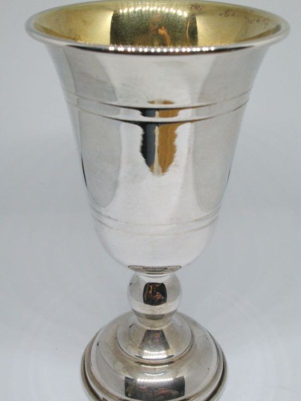 Sterling silver Kiddush cup smooth clean design with four lines engraved around cup. Dimension diameter 7.4 cm X 13.1 cm approximately. 