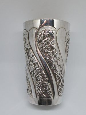 Sterling Silver wine grapes Kiddush goblet Cup with engraved and hand hammered grapes designs around. Dimension diameter 6.5 cm X 10.4 cm approximately.