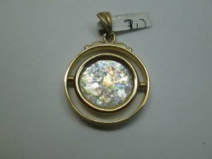 14 Carat Gold Pendant Roman glass Round. 14 carat gold pendant handmade & set with ancient Roman glass in a round pendant that the center piece turns around. Dimension diameter 2.4 cm X0.35 cm approximately.