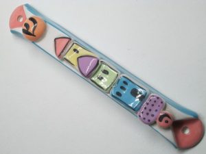 Glazed ceramic Mezuzah pastel colors with houses suitable for parchment up to 10 cm length. Dimension 2 cm X 2.25 cm X 15.7 cm approximately.