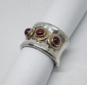 Handmade 14 carat gold and sterling silver concave ring contemporary style ring set with 3 Garnet stones silver 1.45 cm ring size 55.