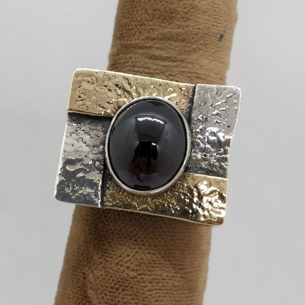 Handmade sterling silver gold Garnet ring & 14 carat gold contemporary hammered style ring set with Garnet stone & hammered silver.