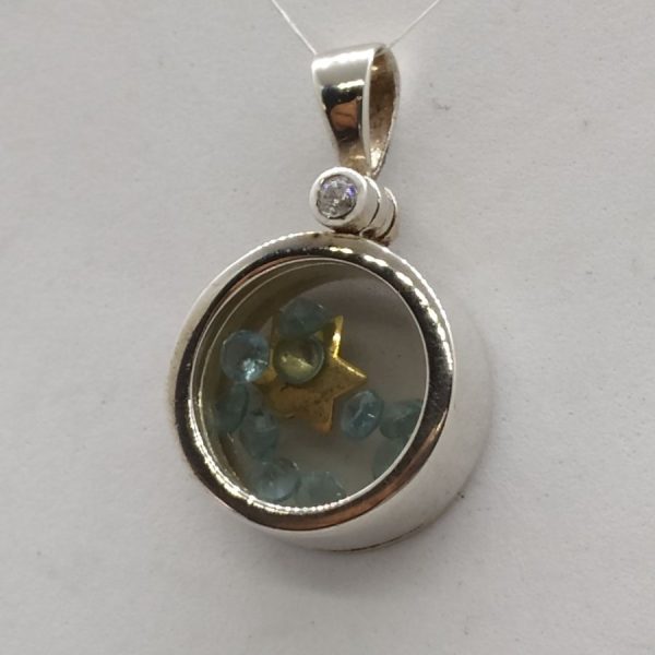 The David Star Blue Topaz pendant star and stones are loose in its round sterling silver frame. Dimension diameter 1.6 cm X 0.6 cm.
