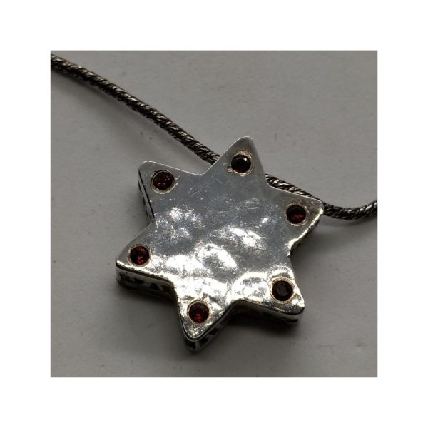 Handmade contemporary sterling silver and 14 carat gold MagenDavid Star Hammered Gold hammered set with Garnets on one side of star.