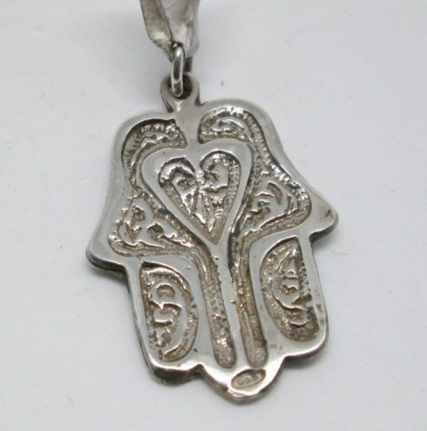 Handmade sterling silver Hamsa Chamsa pendant heart shape hand engraved in heavy solid silver. Dimension 2 cm X 2.7 cm X 0.12 cm approximately.