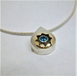 Handmade sterling silver & 14 carat gold Blue Topaz Silver Necklace set with blue Topaz in a silver tear drop pendant. Chain length 40 cm.
