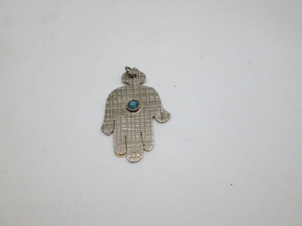 Handmade sterling silver Hamsa pendant One Turquoise with engravings designs. Dimension 2 cm X 2.5 cm X0.1 cm approximately.