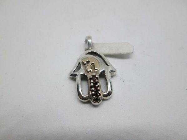 Sterling Silver Hamsa Chamsa Pendant Gold Chai. Handmade Hamsa set with 3 Garnet stones & 14 carat gold Hay. Dimension 1.55 cm X 2 cm X 0.4 cm approximately. The Hamsa Khamsa Chamsa is considered in this era as an amulet to protect from the evil eye. Its name Hamsa chamsa or Khamsa derives fro the Arabic language five. It is also known as the famous "Fatima Hand"( the daughter of Muhamad) it has the palm shape hand. It is well known all over the middle East to wear a Hamsa as jewelry or have it hung on your home walls , so for protection against the evil eye. There are many theories as for its origin, as ancient Carthage (Tunisia) or ancient Egypt and Mesopotamia (Iraq). One can see on antiquities of the mentioned countries many home ornaments with the protecting Hamsa hand. It is containing usually a symbolic blue eye in center. One can add the word Hamsa verbally in a discussion , once he feels menaced by a said his adversary. In Jewish spiritualism there is notable amount of use of the hand in amulets and manuscripts. It is being used mostly by Sephardi Jews in the past two centuries.. In the Torah there are many references to the "Hand of G-D"  " Strong Hand" "Right Hand". During centuries there was an evolving jewelry industry to create Hamsa design for that purpose. The same was for wall decorations. The Christian faith too has a connection to the Hamsa and well known as the hand of Mary or the Virgin Mary Hands.  If you happen to see an item you like , but want to have any alteration , please let me know. Many of the products can be made in gold or silver. Visit my eBay site :PENDANT STERLING SILVER STAR OF DAVID PENDANT MASCULINE HEAVY LOOK Facebook connection : Y.Sh.Ghatan & Sons For gold Star of David :Star of David Gold Pendants