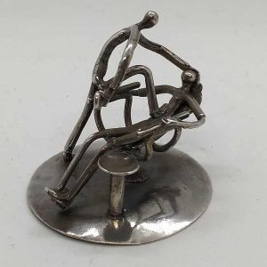 Sterling silver miniature sculpture funny dentist in humorist position to uproot patient tooth diameter 3.9 cm X 3.5 cm approximately. 