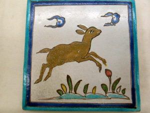 Glazed Ceramic Tile Vintage Young Deer Run . Handmade glazed ceramic tile vintage made in Persia early 20th century. A deer running in the fields.