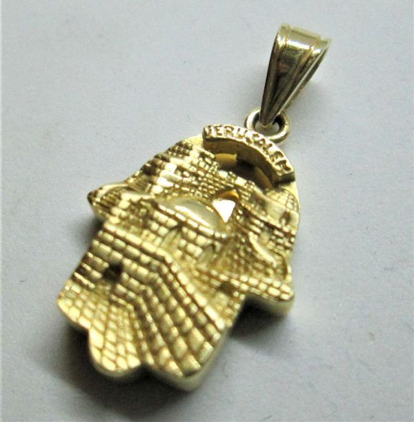 Handmade 14 carat gold Chamsa Hamsa pendant Jerusalem carvings designs of Jerusalem old city western wall and monuments carved in.