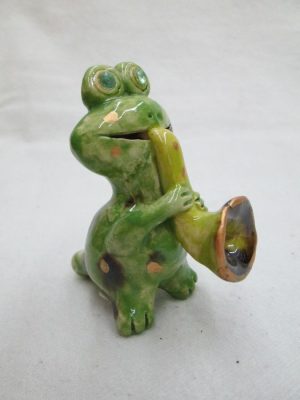 Handmade glazed ceramic frog playing jazz, it is also a whistle made by T. Labok. Dimension 6.8 cm X 6.1 cm X 3.3 cm approximately.