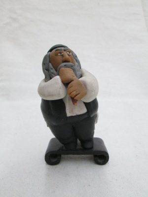 Handmade humoristic fimo ceramic a Chasid Rabbi playing flute made by Yuri. Dimension 9 cm X 5.4 cm X 5.2 cm approximately.