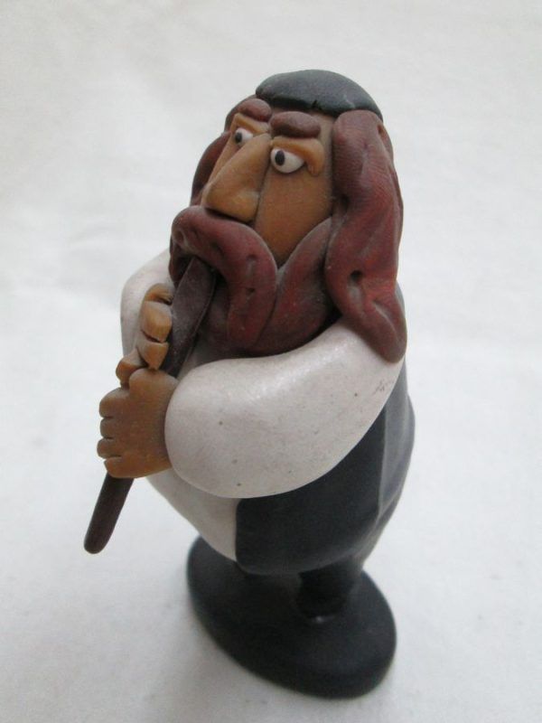 Handmade fimo ceramic a Shabby Rabbi playing flute made by Yuri. Dimension 10.7 cm X 5.8 cm X 4.2 cm approximately.