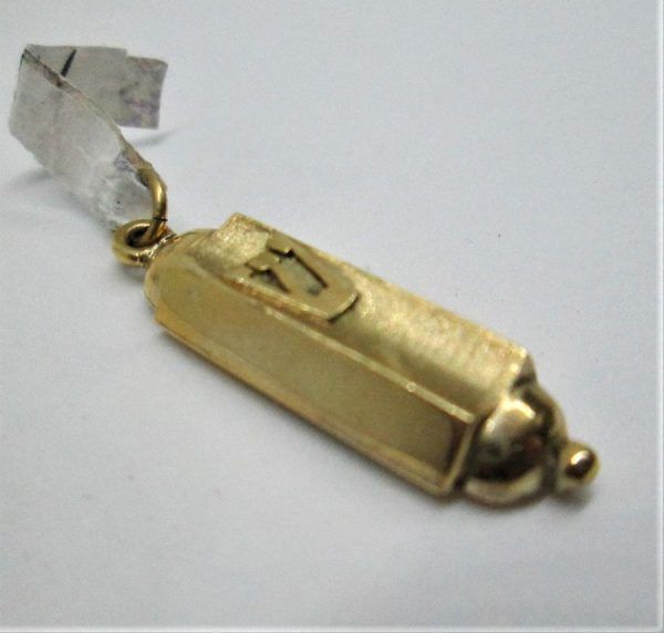 Handmade 14 carat yellow gold Mezuzah pendant Shin raised letter white gold. Dimension 0.8 cm X 2.5 cm approximately.