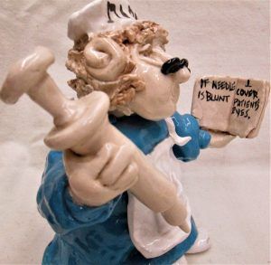 Handmade glazed ceramic a shabby Jewish nurse sculpture learning how to treat patient with needle made by Jacqui Lavon.