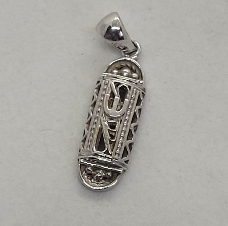 18 carat white gold Yemenite Filigree Mezuzah pendant white gold solid hand made in Israel. Dimension 0.6 cm X 2.4 cm X 0.5 cm approximately.