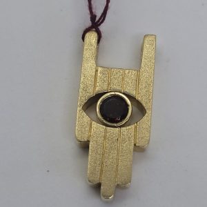 Handmade 14 carat gold Contemporary Hamsa Huge Pendant designed Hamsa set with a faceted Garnet as an eye shape 1.3 cm X 3 cm X 0.46.
