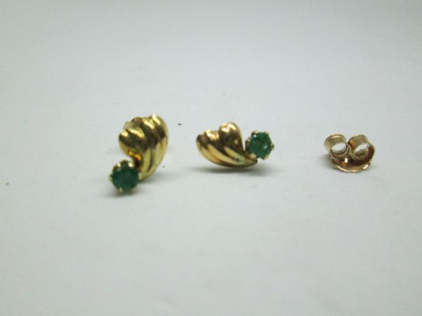 Handmade contemporary design 14 Carat gold earrings two Emeralds genuine stones set in. Dimension 0.75 cm X 0.5 cm approximately.
