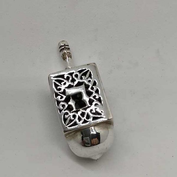 Chanuka Dreidel Silver Cutout designs handmade sterling silver. It has the letters a miracle happened here. Size 1.7 cm X 1.7 cm X 4.4 cm.
