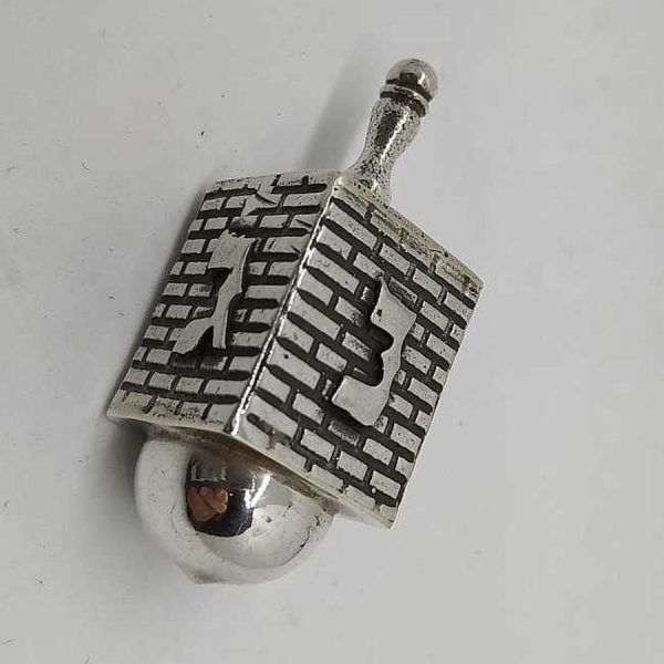 Hanukah Dreidel Silver Kotel Stones. Handmade sterling silver dreidel Kotel design . Dimension 1.8 cm X 1.8 X 4.1 cm approximately.