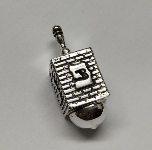 Hanukah Dreidel Silver Kotel Stones. Handmade sterling silver dreidel Kotel design . Dimension 1.8 cm X 1.8 X 4.1 cm approximately.