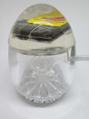 RoshHashana honey dish Perspex with a sugar cube and tea bag in Perspex cover.  Dimension diameter 8.8 cm X 11.2 cm approximately.