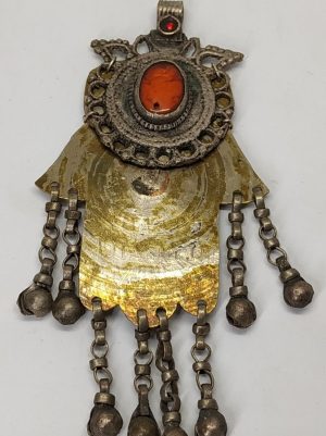 Handmade vintage brass Hamsa pendant with Hebrew Kabbala blessings against evil eye and ornate with red glass made in the middle east early 19th century.