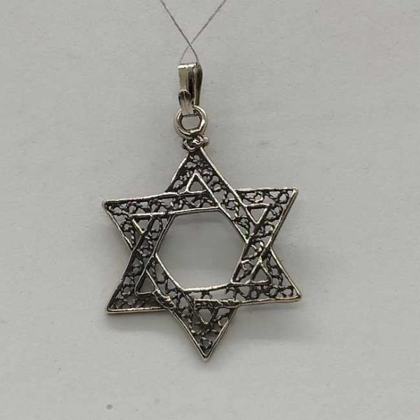 Sterling Silver Magen David Star Pendant Yemenite Filigree Classic fine filigree and oxidized so to give a nice antique look. Dimension 2.6 cm X 3.5 cm X 0.1 cm approximately. One can find a wide variety of star of David pendants in silver , gold and other cheaper materials. There are designs for women ,men and children different sizes to suit every desire. Star of David is known in Hebrew Magen David  or the Shield of David is a generally recognized symbol of modern  Jewish identity and Judaism.  Its shape is made by 2 triangles  forming a hexagram, combination of two  equilateral triangles.  The star of David has been adapted into a variety of many culture, but in different meanings. Nowadays it is symbolizing the state of Israel's flag since the first Zionist congress in 1897. Before that it was used in Christianity to decorate churches in medieval time. Only later 19th century it has been used by eastern European Jewish communities as their Jewish symbol. The Zohar (Kabbalah) gives a spiritual explanation as for the star of David triangles. The first triangle has the connection of G-D , Torah and The sons of Israel.  The second triangle is reflected by G-D , the study of Torah and the study of the Zohar. By doing these learning the Torah and the Zohar you approach yourself to G-D. The fact that in a triangle each of The three corners of the triangles are connected with each other .  It demonstrates that the Jewish soul is itself knotted to G‑d Through the Torah study and observance. By that connection between the Jew and G‑d and the Torah study it merely brings it to light. Visit my eBay site :PENDANT STERLING SILVER STAR OF DAVID PENDANT MASCULINE HEAVY LOOK Facebook connection : Y.Sh.Ghatan & Sons For gold Star of David :Star of David Gold Pendants