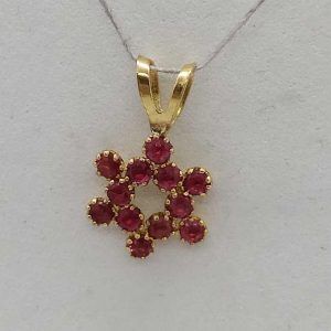 Handmade 14 carat gold 12 Rubies Magen David star pendant set in and forming a star of David 1.35 cm X 0.8 cm X 0.1 cm approximately.