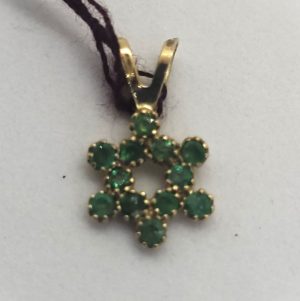 Handmade 14 carat gold 12 Emeralds Magen David star pendant set in and forming a star of David 1.35 cm X 0.8 cm X 0.1 cm approximately.