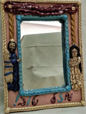 Ceramic mirror married couple made by Irena with a new married couple and a Mazel Tov wish in Hebrew at bottom of Mirror.
