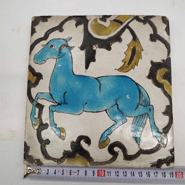 Vintage Ceramic Tile Horse blue colored. Handmade glazed ceramic tile vintage made in middle East 19th century. A blue horse showing his trained steps.