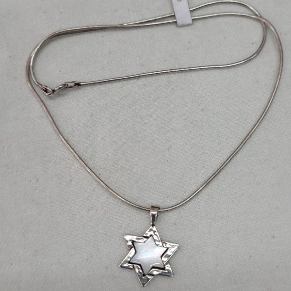 The jeweler has set in the star of David Magen David Mother ofPearl a mother of pearl in center of star 2.4 cm X  1.6 cm X 0.35 cm.