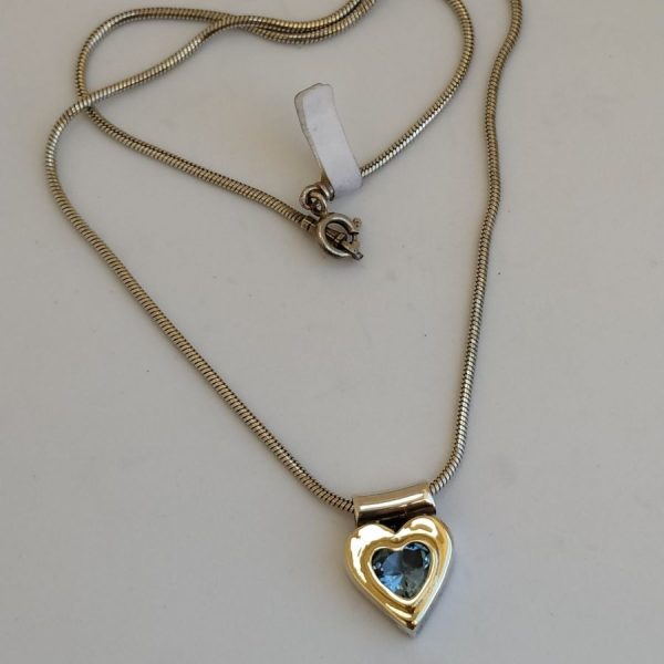 Blue Topaz Silver Necklace heart shape. Handmade sterling silver necklace blue Topaz set in heart shape pendant with 14 carat gold on top.