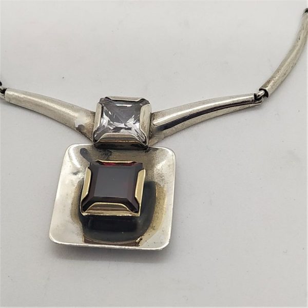 Contemporary Sterling Silver Necklace set with Garnet and white Zircon stones. Dimension necklace length 42 cm , main pendant 3.3 cm X 2.3 cm X 0.7 cm.