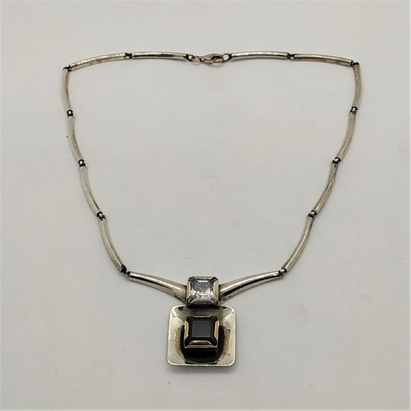 Contemporary Sterling Silver Necklace set with Garnet and white Zircon stones. Dimension necklace length 42 cm , main pendant 3.3 cm X 2.3 cm X 0.7 cm.
