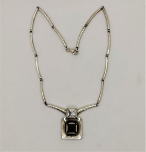 Contemporary Sterling Silver Necklace set with Garnet and white Zircon stones. Dimension necklace length 42 cm , main pendant 3.3 cm X 2.3 cm X 0.7 cm