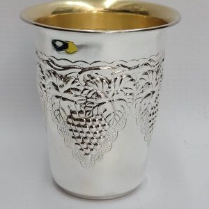 Handmade sterling silver Schnapps cup grapes leaf around designs embossed all around cup. It is hand embossed with vine grapes designs around top of cup.