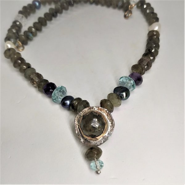 A contemporary beads Labradorite Pearls Amethyst necklace with center pendant silver and 14 carat gold set with Labradorite stone.