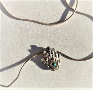 Handmade Hamsa Silver Pendant Contemporary and 14 carat gold Hamsa on top set with Turquoise with snake chain. Silver hamsa pendant 1.6 cm X 1 cm.