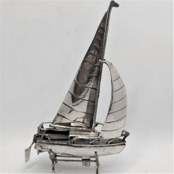 A handmade sterling silver Miniature silver sailing boat with two sailing poles and a sterling silver separate stand 6 cm X 2.8 cm X 10 cm.