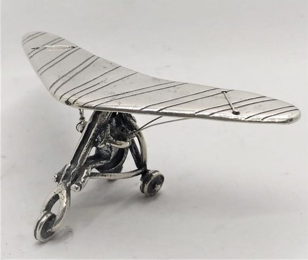 A handmade Sterling silver miniature glider airplane statue. Miniature sterling silver sculptures wide range of original designs.