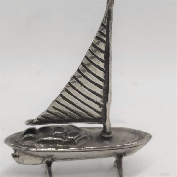 A handmade sterling silver miniature One sail boat Sculpture with one sailing pole .Dimension 4.2 cm X 1  cm X 6 cm approximately.
