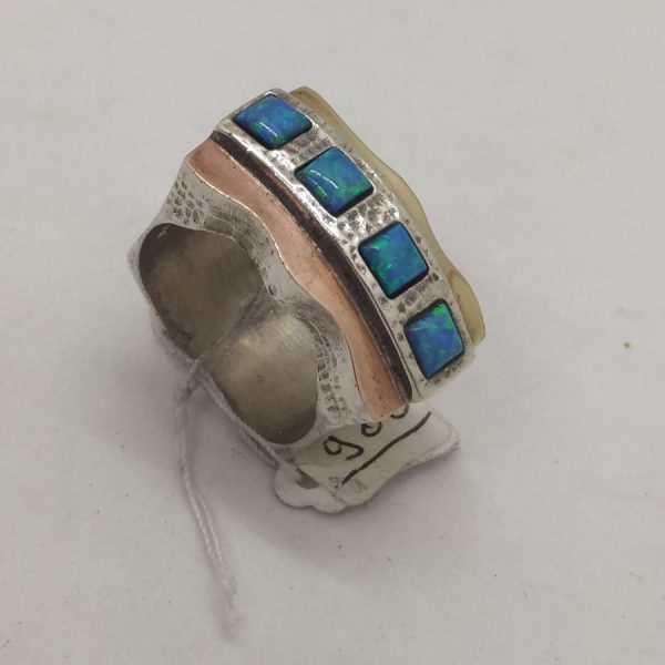 Handmade sterling silver and 14 carat yellow and rose gold Opal ring gold silver . It is set with four square opal stones 2.5 cm X 2.4 cm.