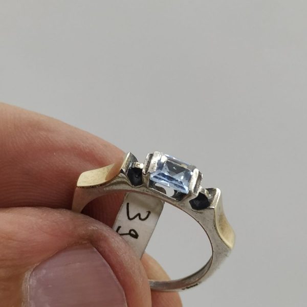 Handmade combined sterling silver and 14 carat gold set with blue Topaz stone ring delicate design. Dimension 0.4 cm X 1.9 cm approximately.
