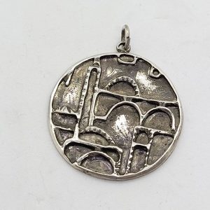 Handmade sterling silver  Jerusalem houses round pendant made by S. Ghatan. Dimension diameter 3.6 cm X 0.25 cm approximately.