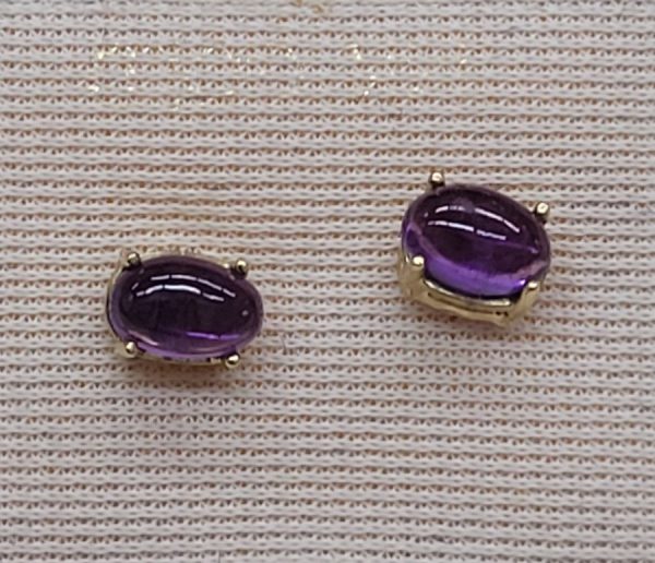 Handmade 14 carat gold cabochon Amethyst stud earrings set with two cabochon purple Amethyst stones handmade.   Dimension 0.4 cm X 0.6 cm approximately.