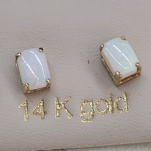 Handmade 14 carat gold cabochon Opal stud earrings set with two cabochon fire Opal stones handmade.   Dimension 0.5 cm X 0.7 cm approximately.